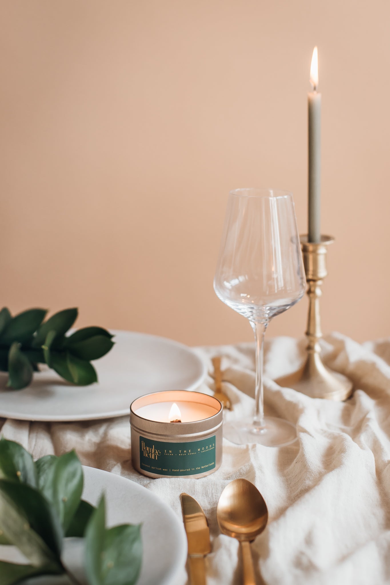 Non toxic vegan Candle, and cutlery on a table with a beige background. Wooden wick 